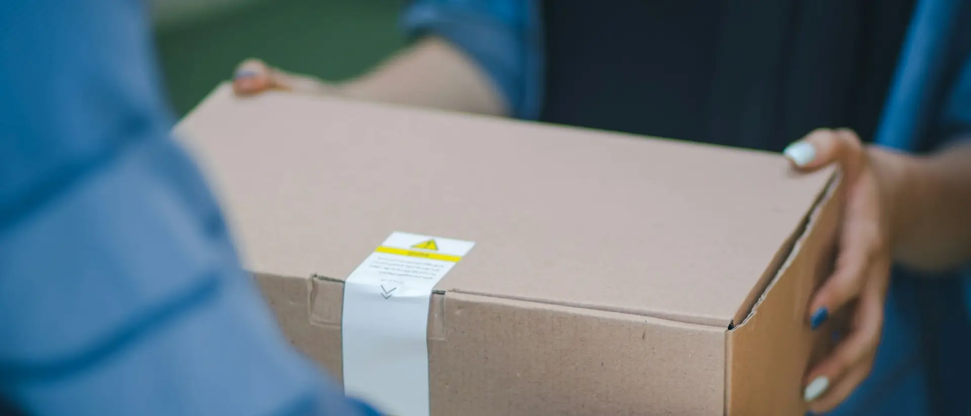 A parcel being handed from one person to another